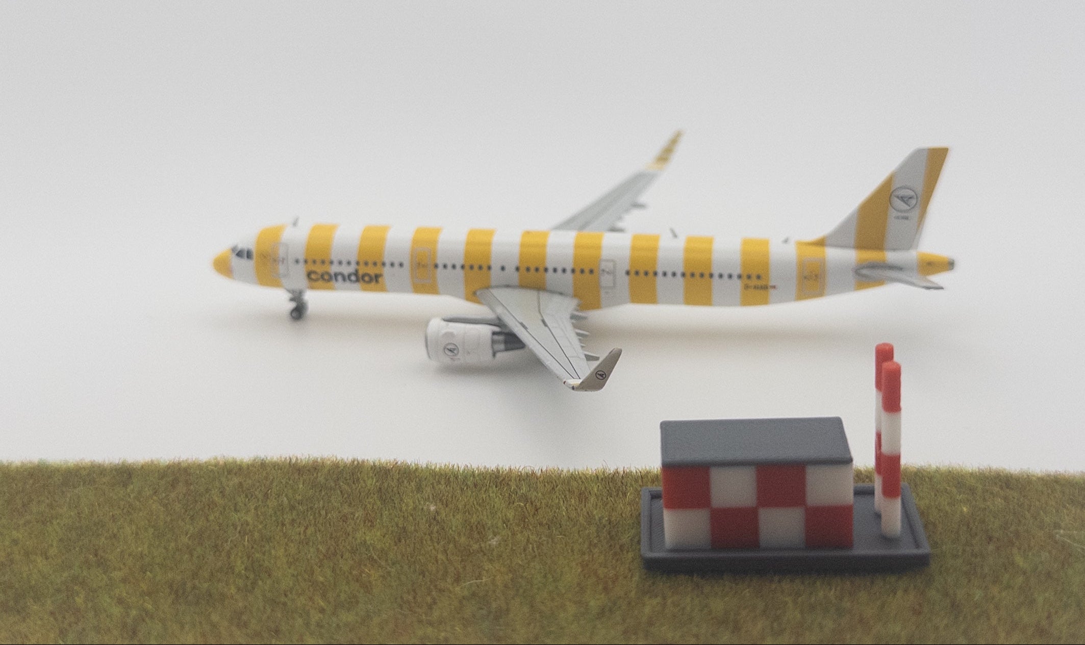 Model airplane with striped design on a white background